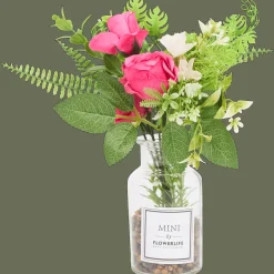 Kunstbloemen in glazen fles